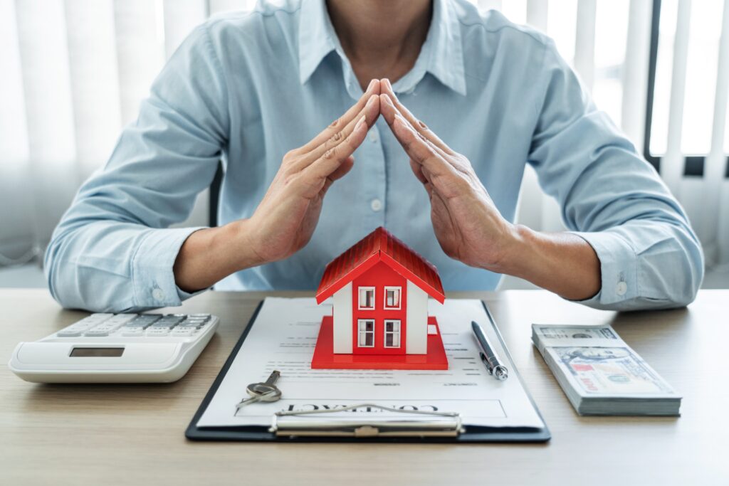 Female real estate agent demonstrating property insurance protection